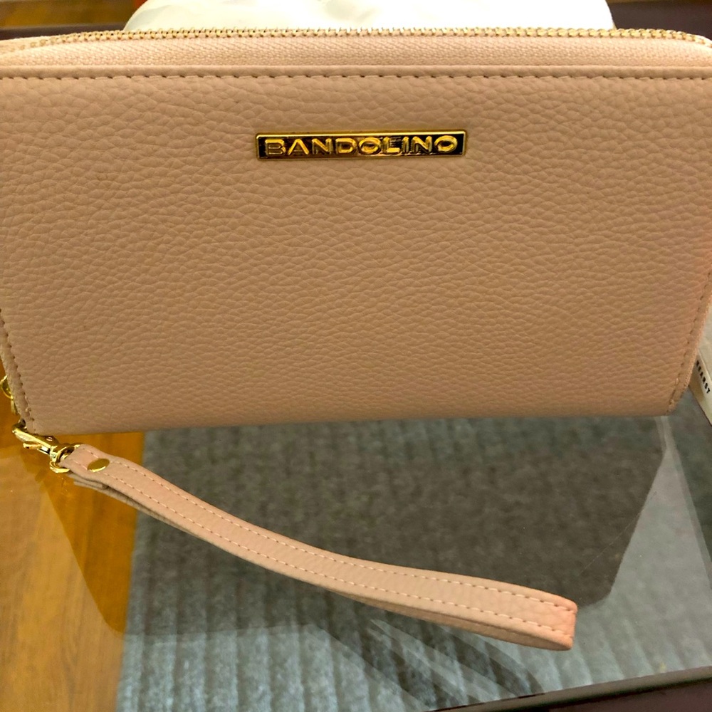 Brand new Bandolino wristlet, very roomy fits phone, cards and cash.